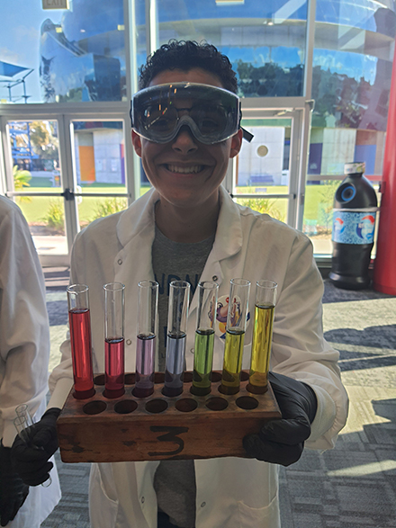 Student, Elliot Santaella Aguilar, holding the pH color indicator. (Photo courtesy of Elliot Santaella Aguilar)